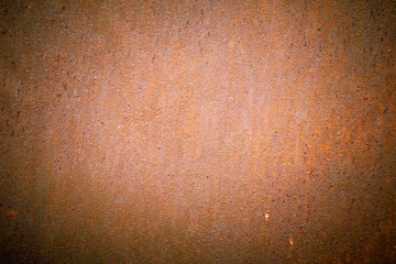 Old metal orange sheet with rust streaks. Rust texture for background. Vignette around the edge of the frame.