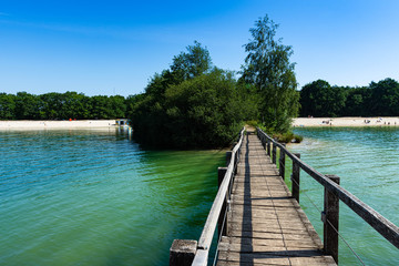 Bridge over the lake with a beach in the background