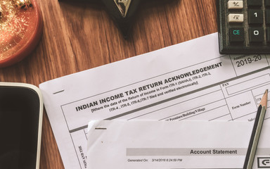 Close up of Indian Income tax return form ITR-2 return form is on the table next to a pen, calculator and a home mortgage loan application form placed on the desk. Financial Business concept.