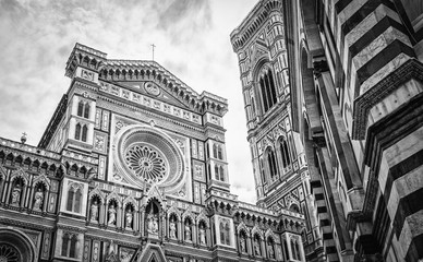 The Cathedral of Santa Maria del Fiore in Florence Italy. Black and white photography of facade of the Cathedral and the Baptistery with cloudy sky