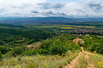 Obraz premium A view from path on the slope of the Stob Pyramids to the valley of the village of Stob, Rila mountain, Kyustendil region, Bulgaria, Europe 