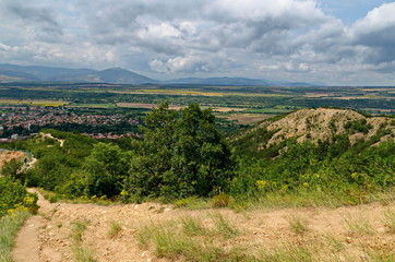 Fototapeta na wymiar A view from path on the slope of the Stob Pyramids to the valley of the village of Stob, Rila mountain, Kyustendil region, Bulgaria, Europe 