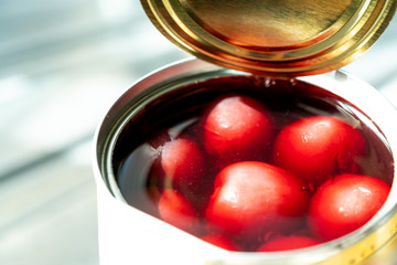 Preserved cherries in syrup in the opening can using as sweet pie or ingredient for dessert
