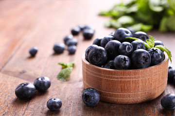 Ripe Fresh Blueberries in wooden bowl
