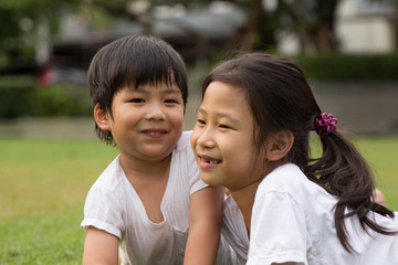 Thai Sister and brother having fun and happiness in a park