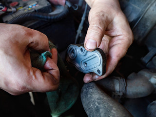 men's hands wipe the car detail, home repair of his car, close-up