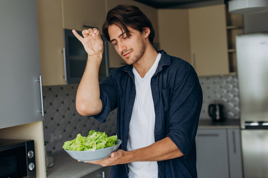 Closeup portrait of man preparing a salad. - Image