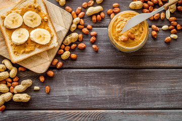 sandwiches with peanut butter and banana for breakfast on wooden background top view space for text