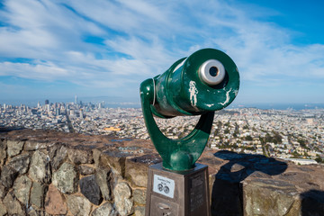 A telescope looking towards San Francisco City from Twin Peaks, California, USA