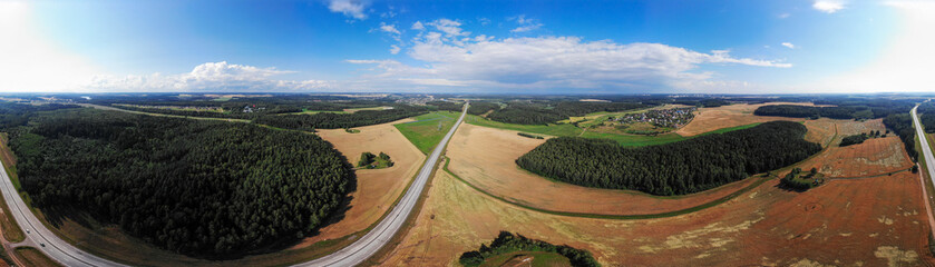 Fields. They harvest wheat and rye, collected in stacks. Photo from quadcopter. Autumn harvest. The concept of modern agriculture. Sky view.