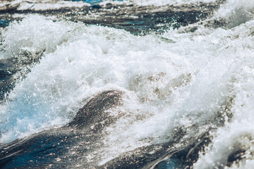 Bursts and rapids of close-up mountain river, waves and splashes
