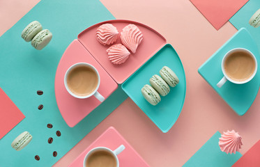 Geometric paper background in mint and coral colors with coffee and sweets