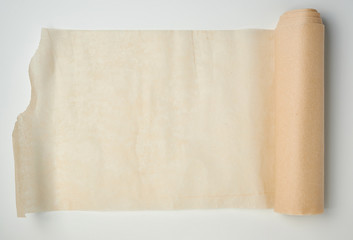 light brown roll with parchment paper spun on a white background