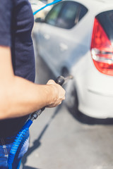 Self service car wash station with pressurized water outdoors