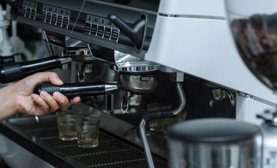 Fototapeta na wymiar Indoor.A coffee making machine.Coffee machine operating platform.Hold the handle of the coffee machine.To clear coffee machine.