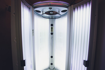 Vertical Tanning turbo Solarium Light Machine with glowing blue light ultraviolet lamps for tanning...
