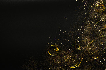 Golden sparkles and ribbons on black background. Festive concept. - Image