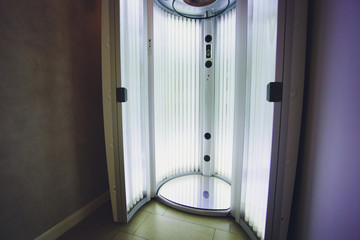Vertical Tanning turbo Solarium Light Machine with glowing blue light ultraviolet lamps for tanning...