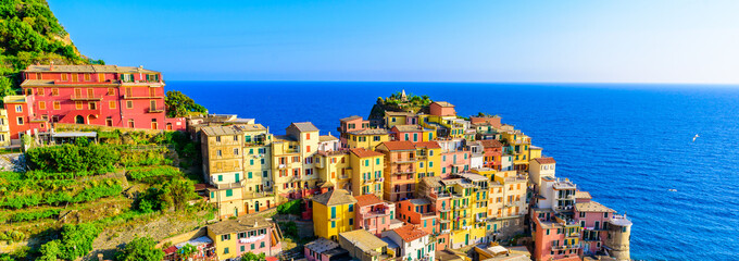 Colorful houses in Manarola Village in Cinque Terre National Park. Beautiful scenery at coast of Italy. Fisherman village in the province of La Spezia, Liguria, Italy - obrazy, fototapety, plakaty