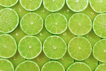 Obraz na płótnie Canvas Fresh lime slices as a background.