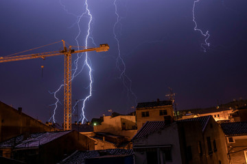 Panoramic view of an old village during a storm with lightnings and thunders - Image