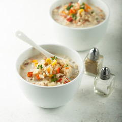 Homemade chowder soup in white bowls
