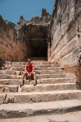 Young man at theatre in Myra ancient city of Antalya in Turkey.