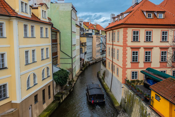 Fototapeta na wymiar water channel with river of Certovka (Devil's Channel) and boat, also called Little Prague Venice, in district of Lesser Town (Mala Strana) Prague, Czech Republic, Europe
