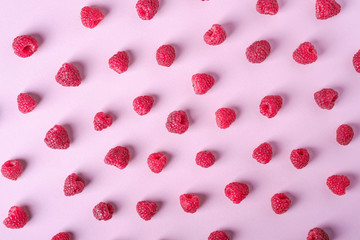 Raspberry sweet organic juicy berries, pattern, texture, on pink paper background, flat lay