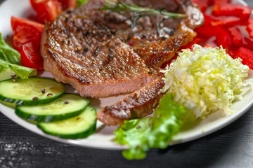 delicious grilled cutted pork meat strewed peppers and salt with vegetable