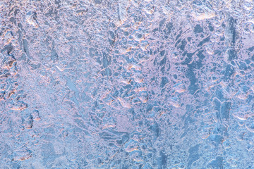 abstract winter ice texture on window, festive frost patterns background, close up