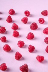 Raspberry sweet organic juicy berries, pattern, texture, on pink paper background