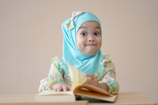 Muslim student kid reading the book in the class.