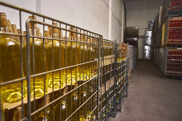 Many bottles are on racks at the winery.