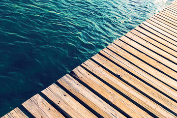 Swimming pool and wooden deck ideal for background, copy space