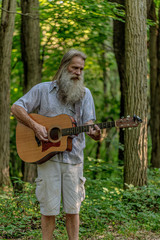Old Man With Big Grey Beard Playing Guitar