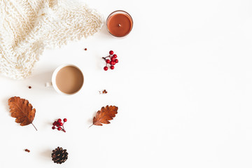 Autumn composition. Cup of coffee, plaid, dried leaves, flowers, rowan berries on white background. Autumn, fall, thanksgiving day concept. Flat lay, top view, copy space