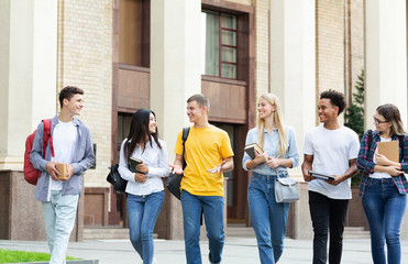 College classmates walking outside the college building