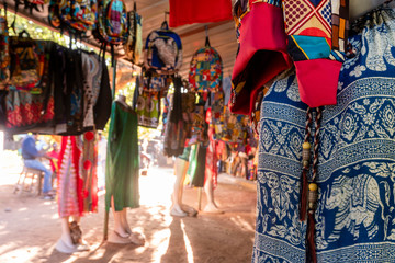 Fototapeta na wymiar Traditional african market selling colorful backpacks, clothes and fabrics, FEIMA, Maputo, Mozambique