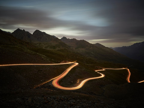 View of illuminated road passing through mountain at night