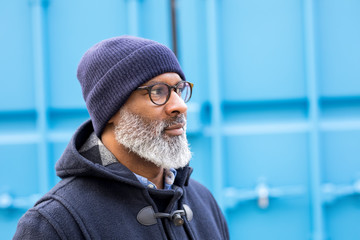 Portrait of man wearing blue woolly hat watching something