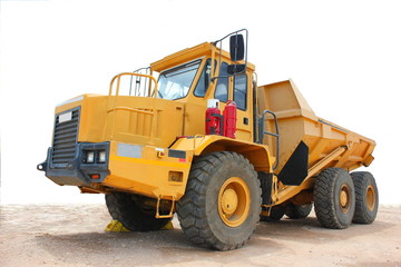 Fototapeta na wymiar A yellow tipper truck used in the mining industry.These trucks are used to move sand,gravel and soil and assist in the process of mining.
