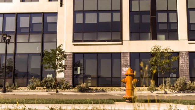 Time lapse of a street view in front of a commercial building with fire hydrant