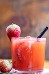 Fresh strawberry drink on wood background, Brazilian Strawberry Caipirinha is on the bar. Space for text. Photo for the menu.