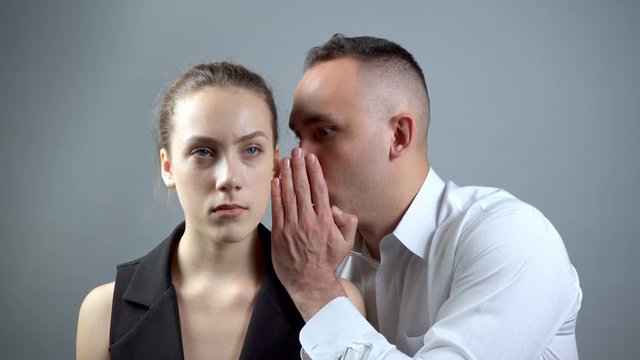 Shooting of two gossipers on grey background