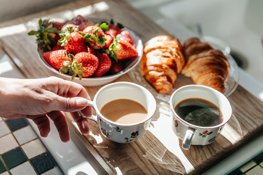 Strawberries, croissants and coffee in kitchen - Powered by Adobe