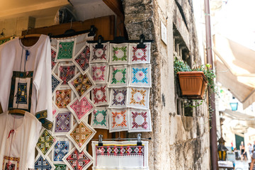 Fototapeta na wymiar Souvenir Croatian embroidery in the old town of Dubrovnik colored geometric cross-stitch patterns