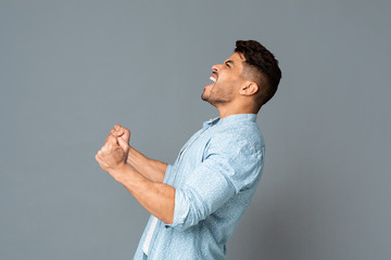 Guy With Clenched Fists Screaming Or Roaring Loudly, Side View
