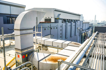 The industrial machine at the rooftop of the huge building.