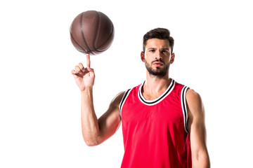 basketball player spinning on finger ball and looking at camera Isolated On White